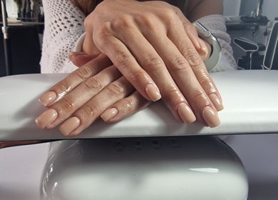Elegant nude manicure on hands at Lisa Luxe Treatments, Birmingham, England, GB.