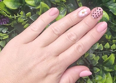 Elegant hand with floral nail art at Lisa Luxe Treatments, Birmingham, England, GB.