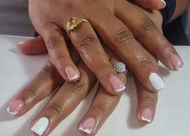 Elegant nail art at Lisa Luxe Treatments, Birmingham, England, GB. Featuring French manicure with gems.