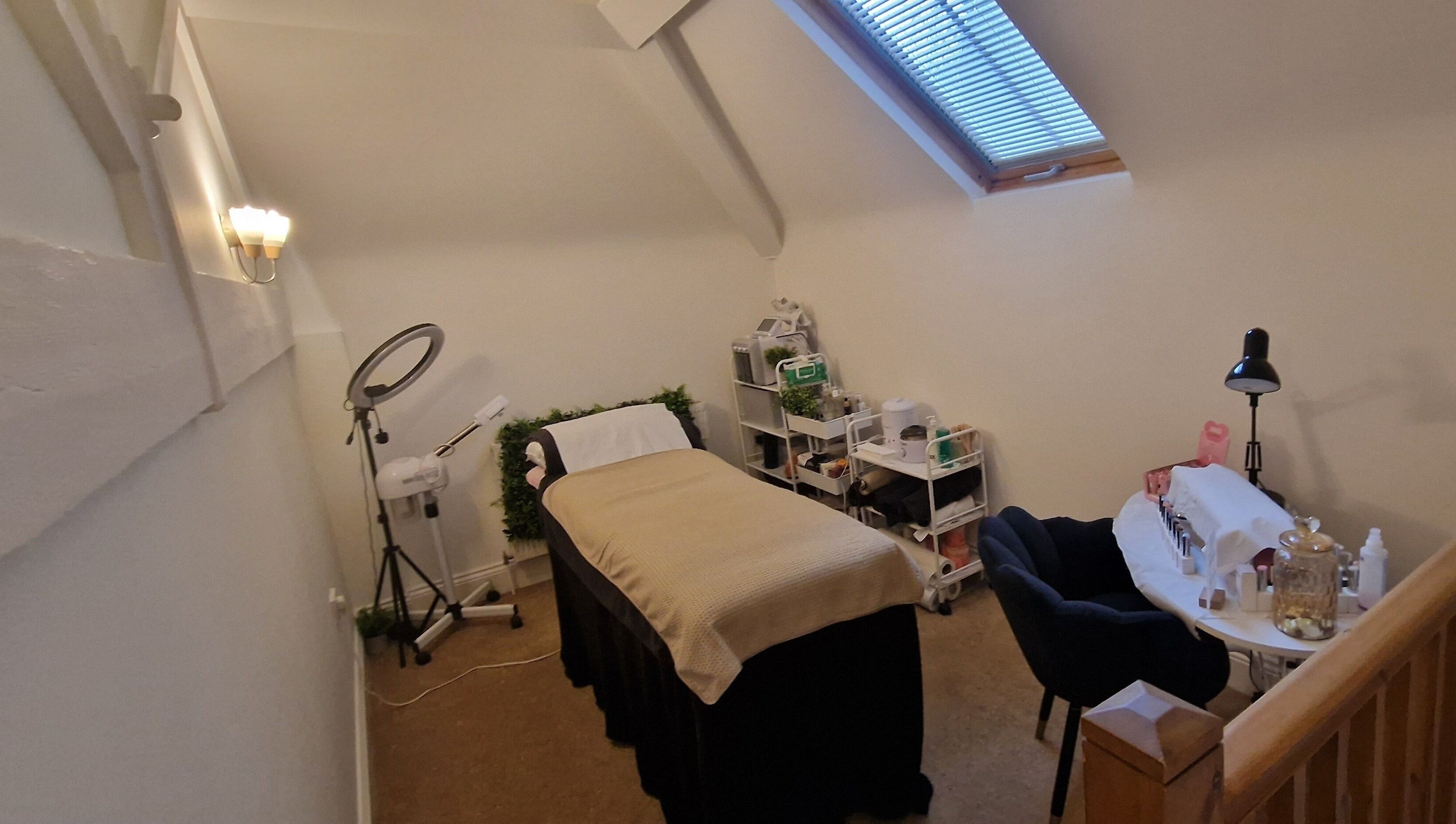 Lisa Luxe Treatments' cozy therapy room in Blackwell, England, GB, featuring a plush massage bed and serene decor.