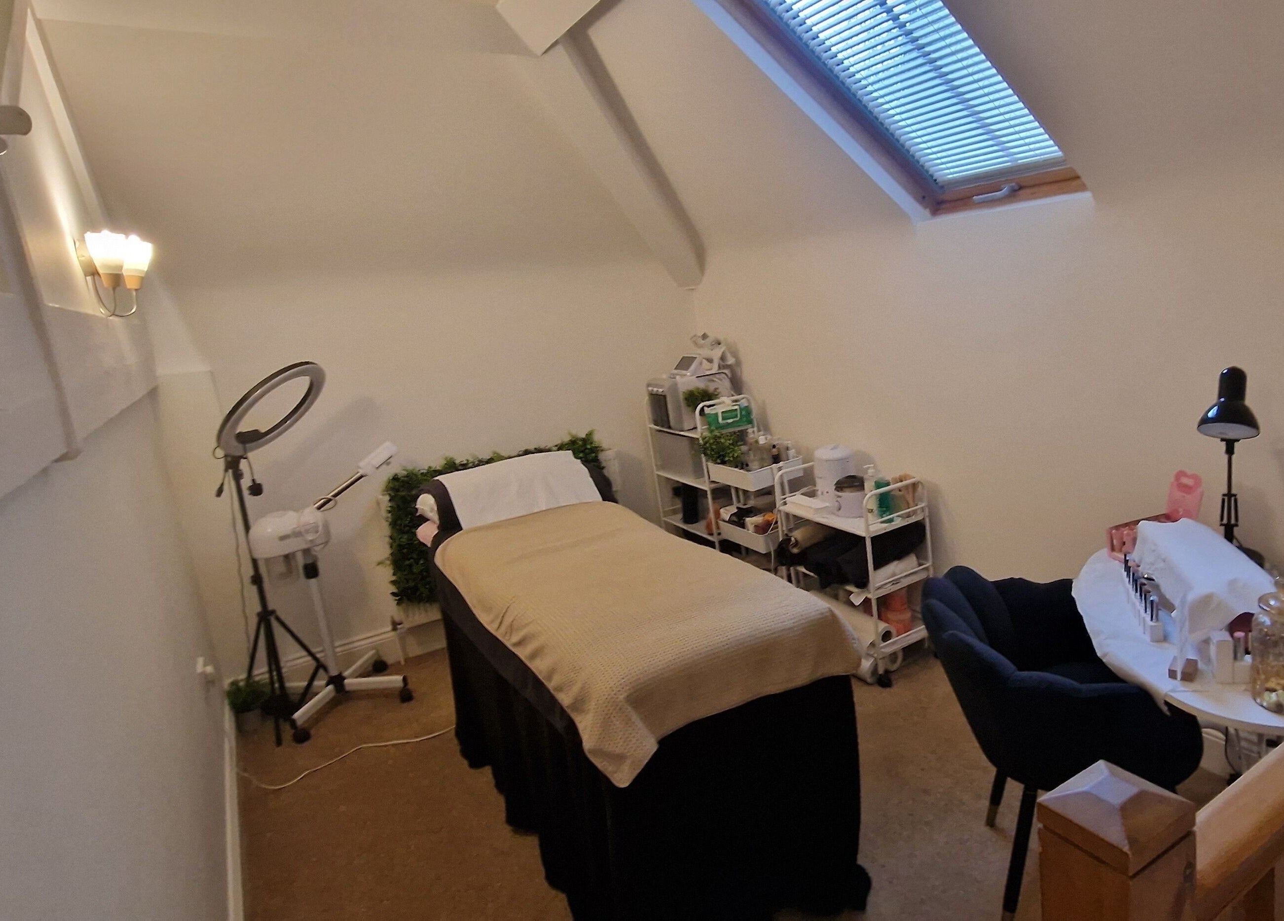 Lisa Luxe Treatments' cozy therapy room in Blackwell, England, GB, featuring a plush massage bed and serene decor.