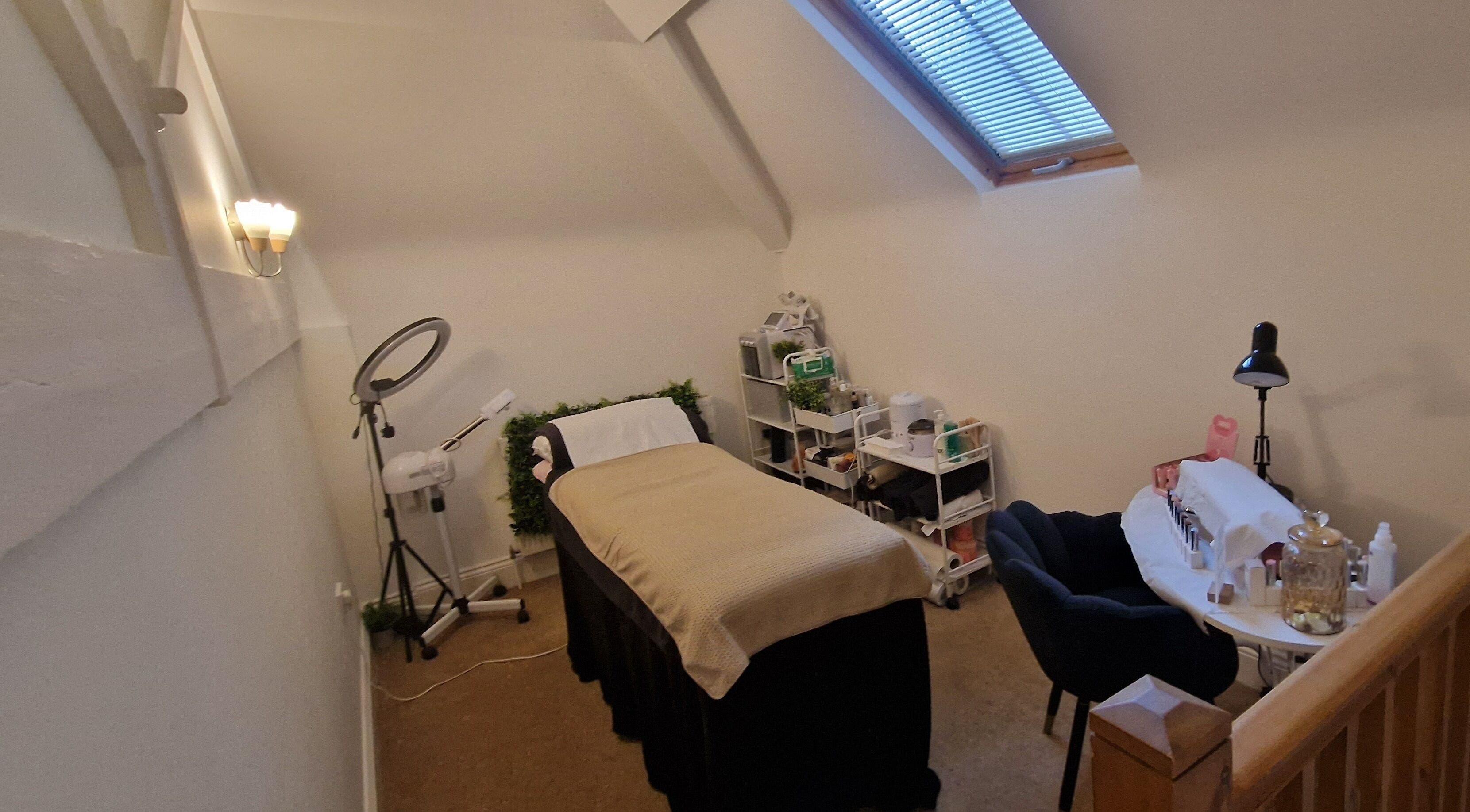 Lisa Luxe Treatments' cozy therapy room in Blackwell, England, GB, featuring a plush massage bed and serene decor.