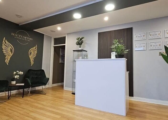 Reception area of Beauty Factory in Gaillimh, Galway, IE with elegant decor and seating arrangement.