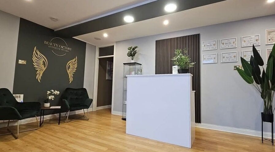 Reception area of Beauty Factory in Gaillimh, Galway, IE with elegant decor and seating arrangement.