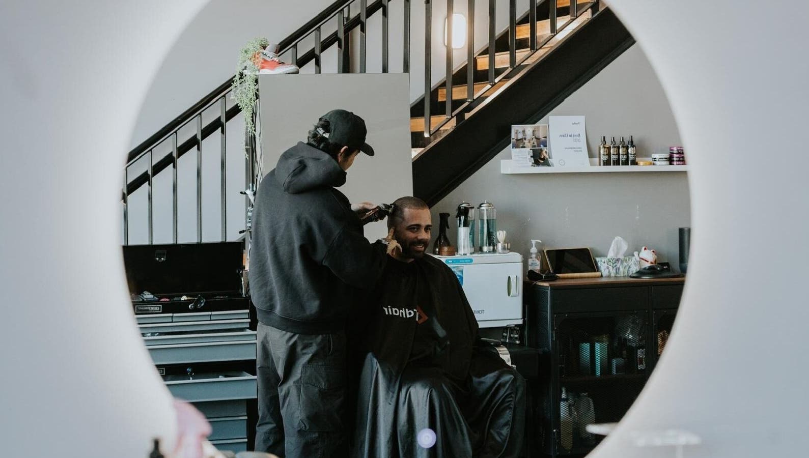 A barber gives a man a haircut at Groundbreak Studio in Phillip, Australian Capital Territory, AU.