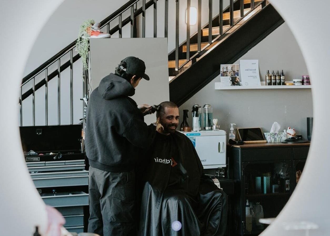A barber gives a man a haircut at Groundbreak Studio in Phillip, Australian Capital Territory, AU.