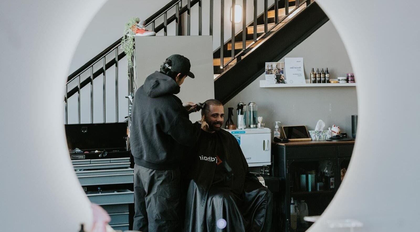 A barber gives a man a haircut at Groundbreak Studio in Phillip, Australian Capital Territory, AU.