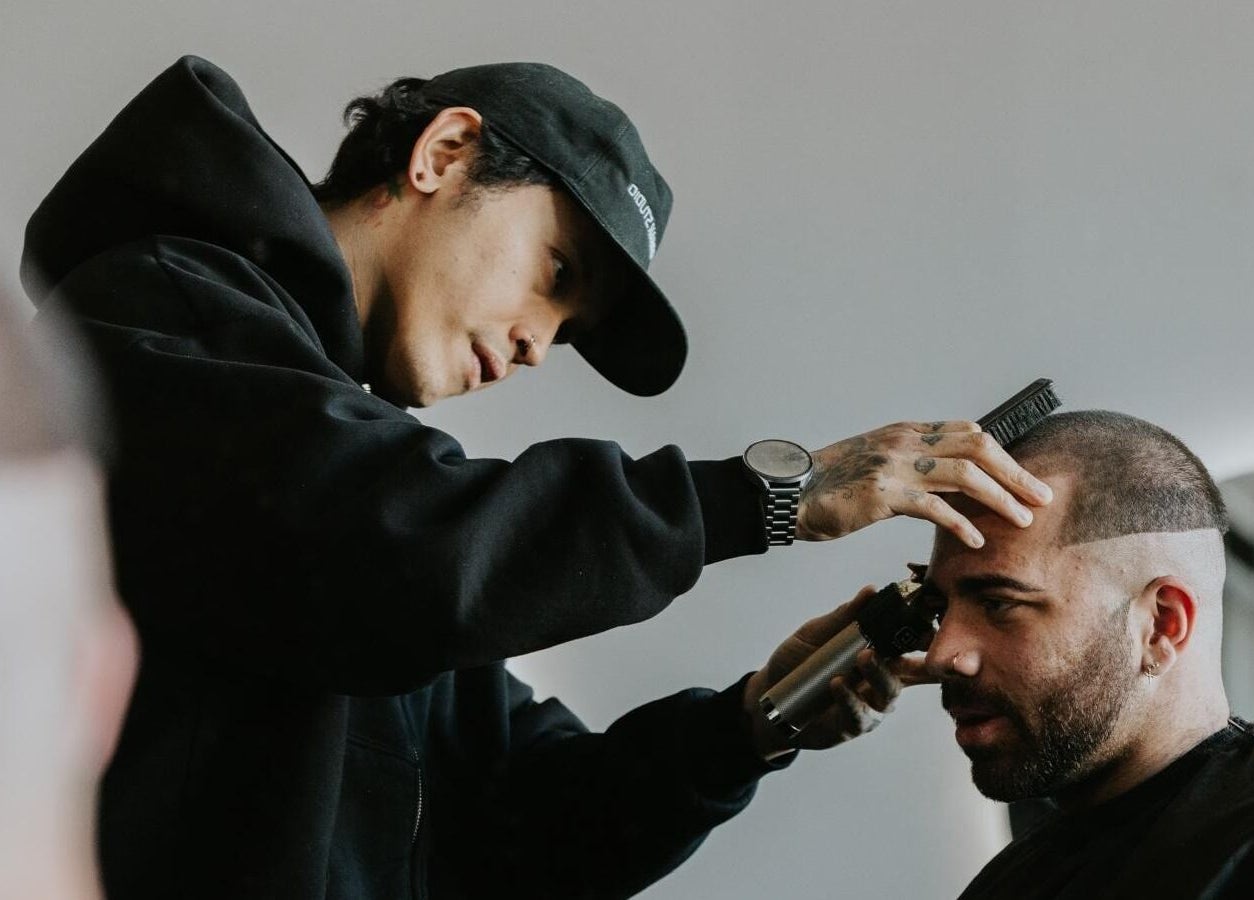 Stylist at Groundbreak Studio in Phillip, AU, giving a precision haircut.