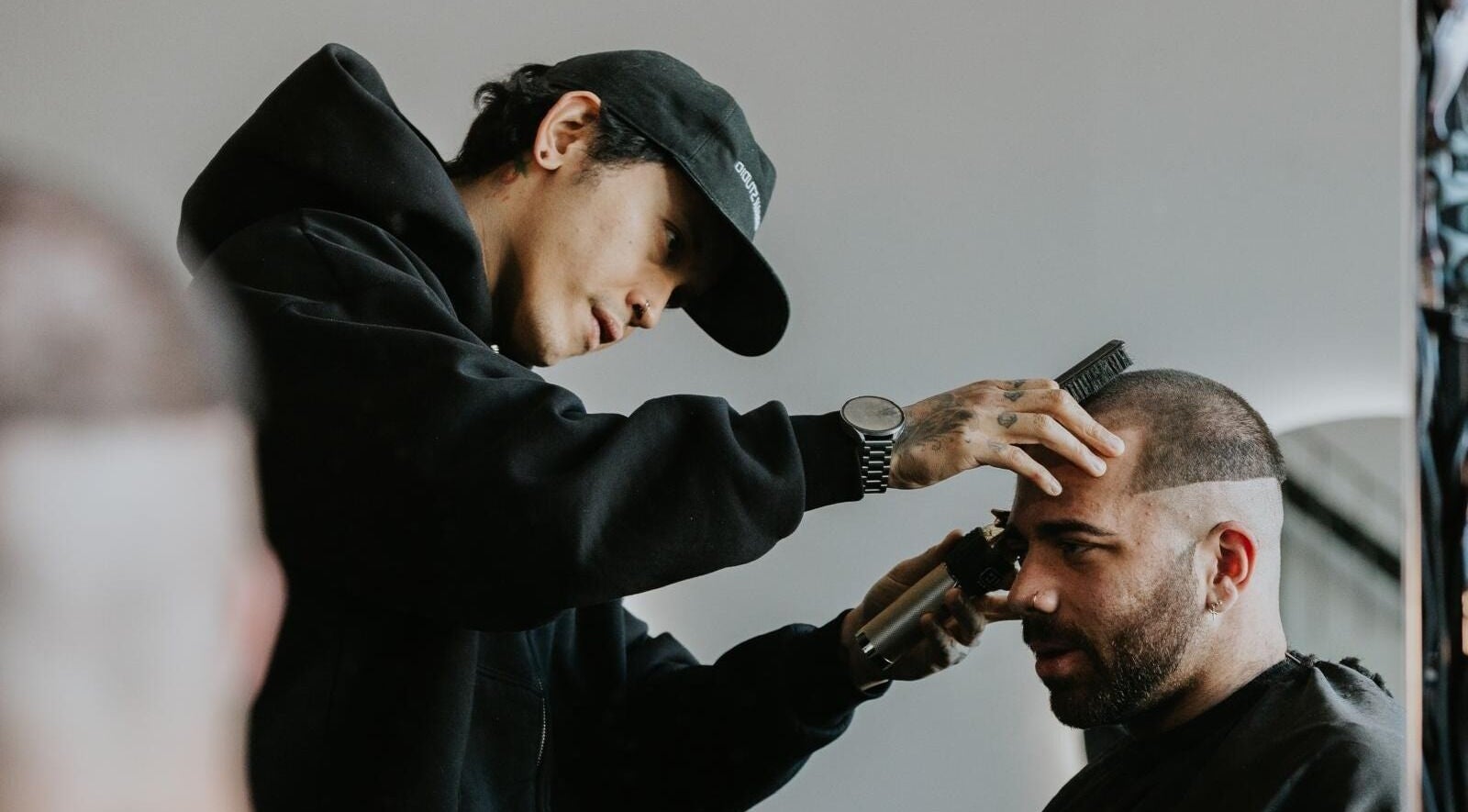 Stylist at Groundbreak Studio in Phillip, AU, giving a precision haircut.