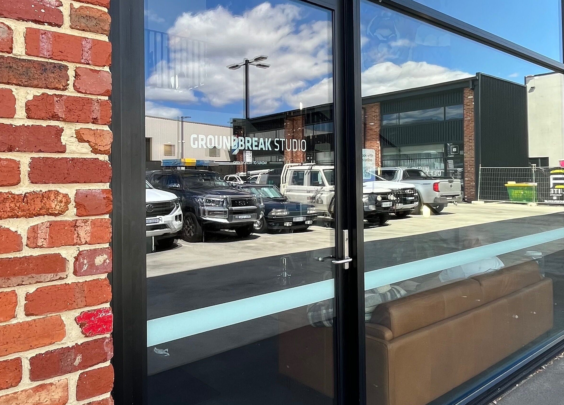 Exterior brick facade of The Cocoon CBR in Phillip, Australian Capital Territory, AU with parking view.