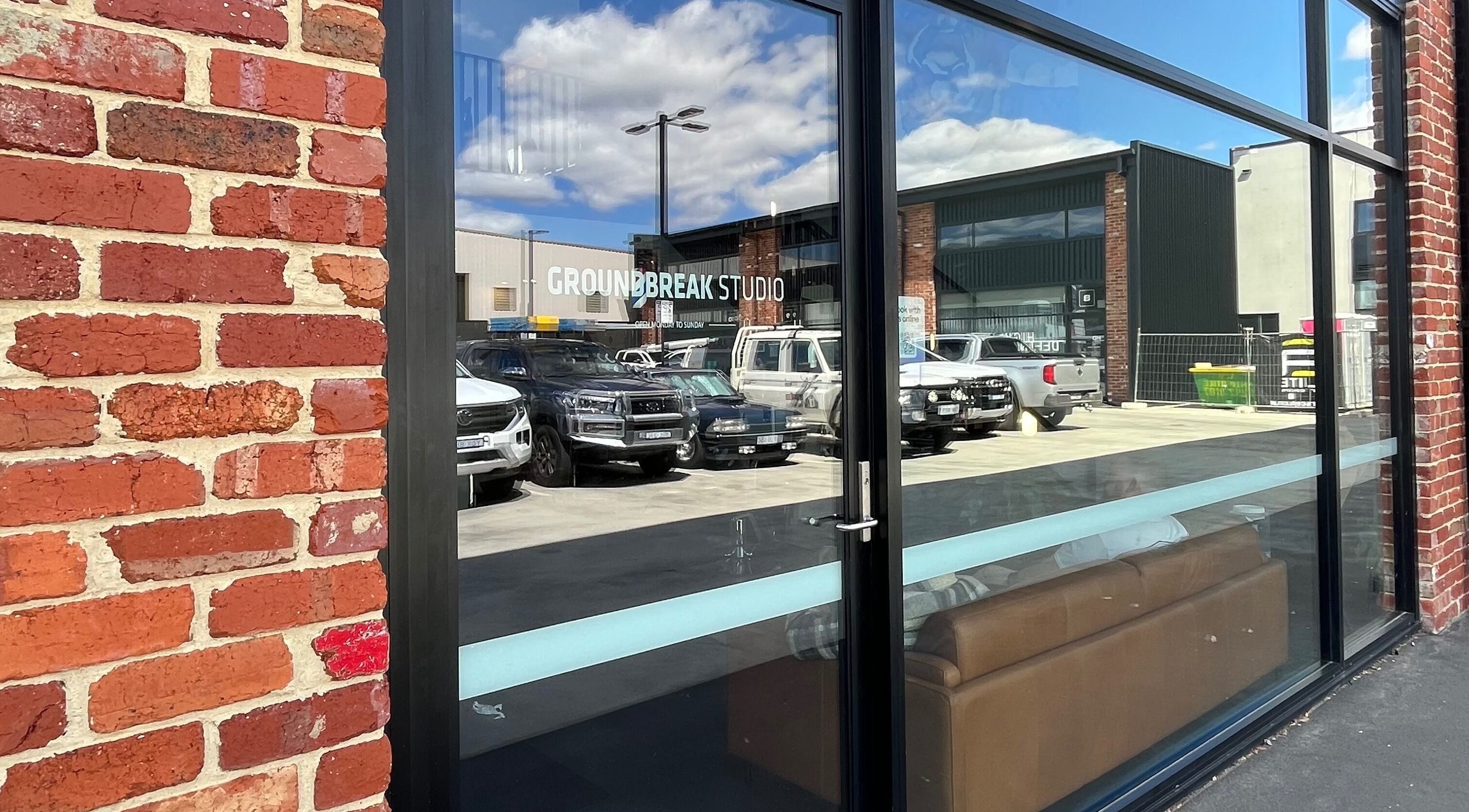 Exterior brick facade of The Cocoon CBR in Phillip, Australian Capital Territory, AU with parking view.