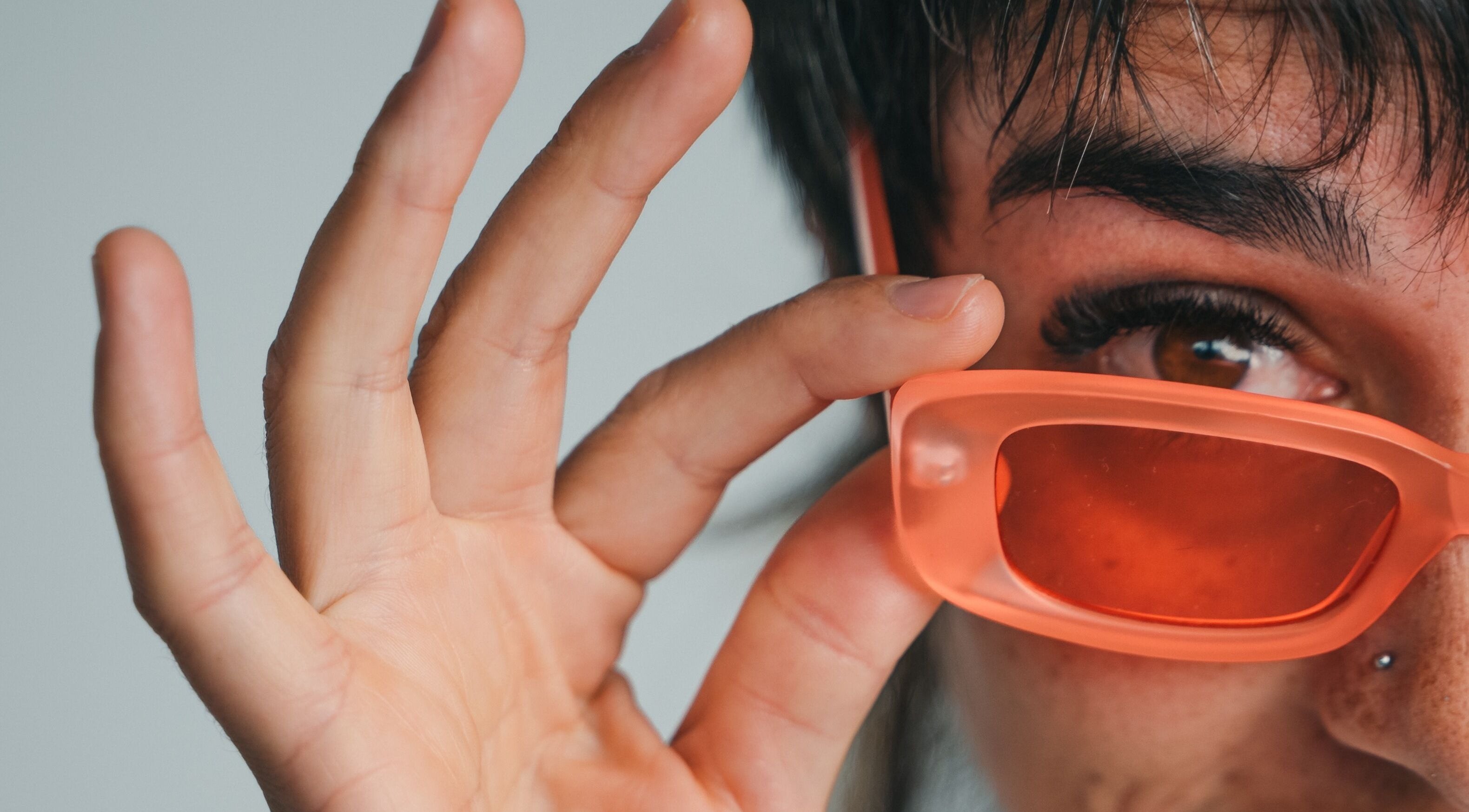 Close-up of a person with peach sunglasses at The Cocoon CBR, Phillip, Australian Capital Territory, AU.