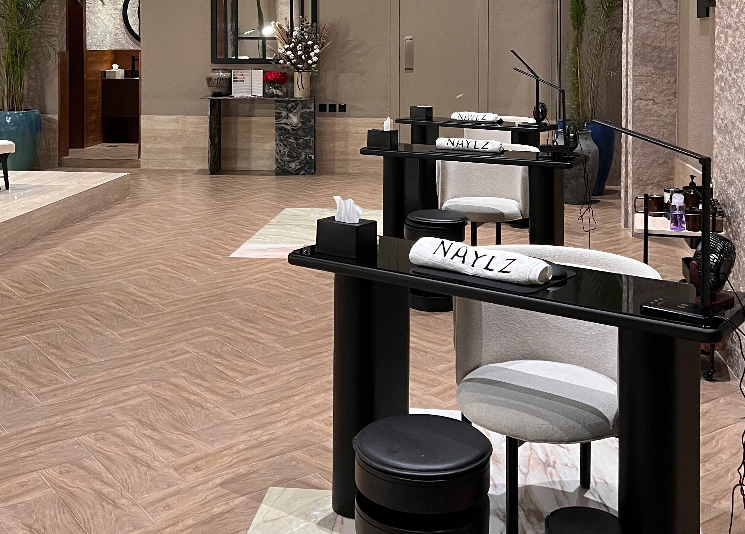 Chic manicure stations at Naylz Spa I نيلز سبا in Riyadh, Riyadh Province, SA with plush seating.