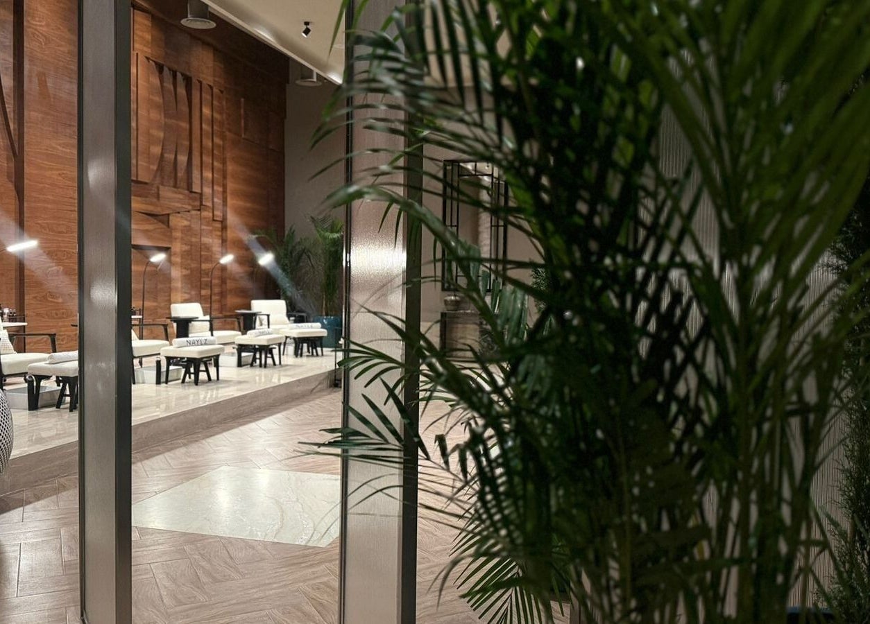 Chic interior of Naylz Spa I نيلز سبا in Riyadh, Riyadh Province, SA with plush seating and lush greenery.