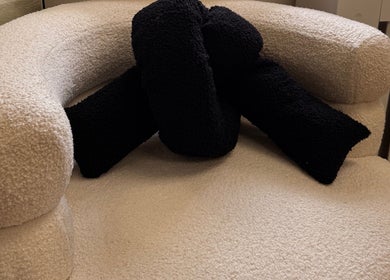 Elegant boucle chair with black cushions at Mabel Studio, Blantyre, Scotland, GB.