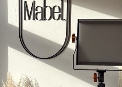 Soft lighting enhances Mabel Studio's logo in Blantyre, Scotland, GB, creating a serene ambiance.