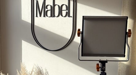 Soft lighting enhances Mabel Studio's logo in Blantyre, Scotland, GB, creating a serene ambiance.