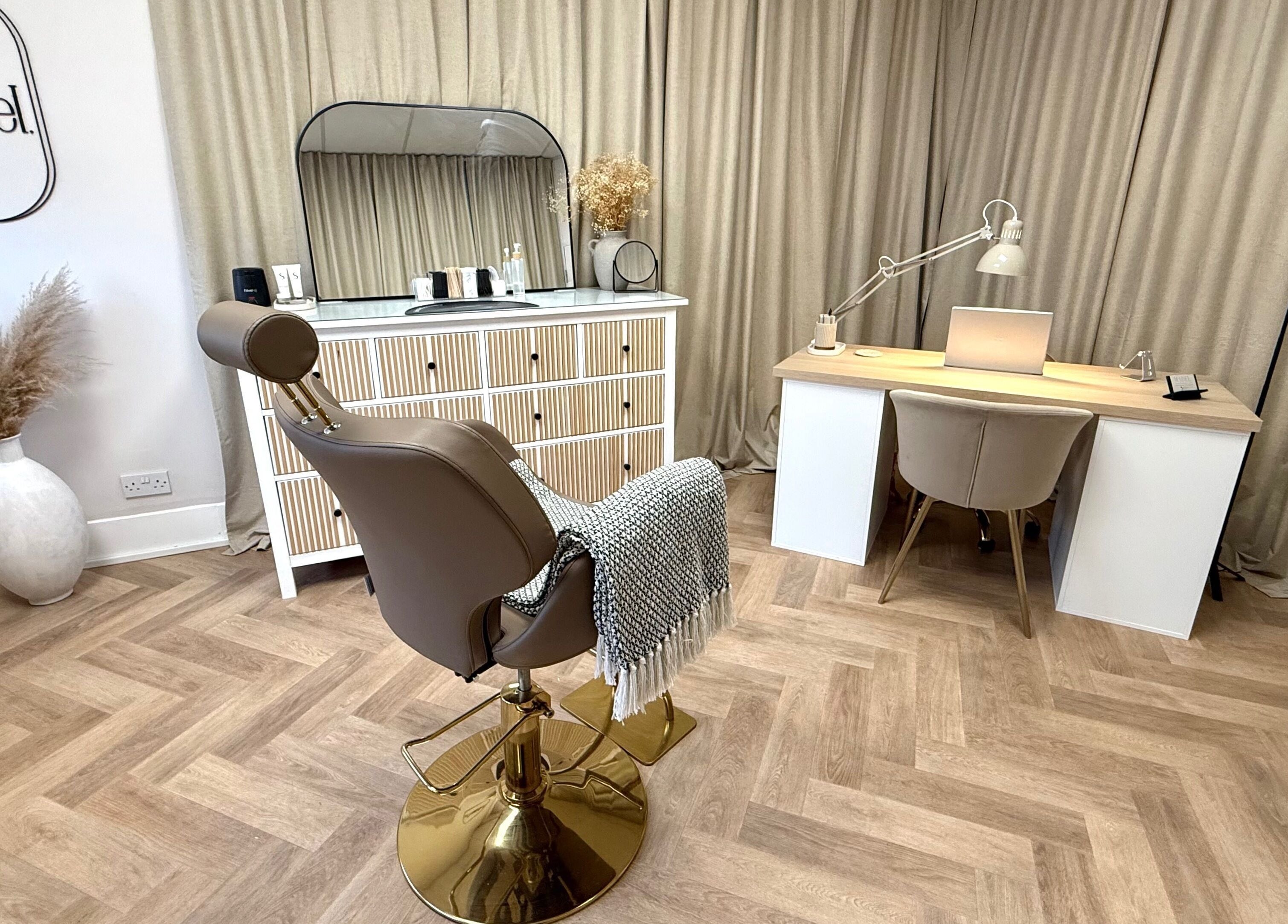 Chic salon interior at Mabel Studio, Blantyre, Scotland, GB, featuring a stylish chair and modern workspace.