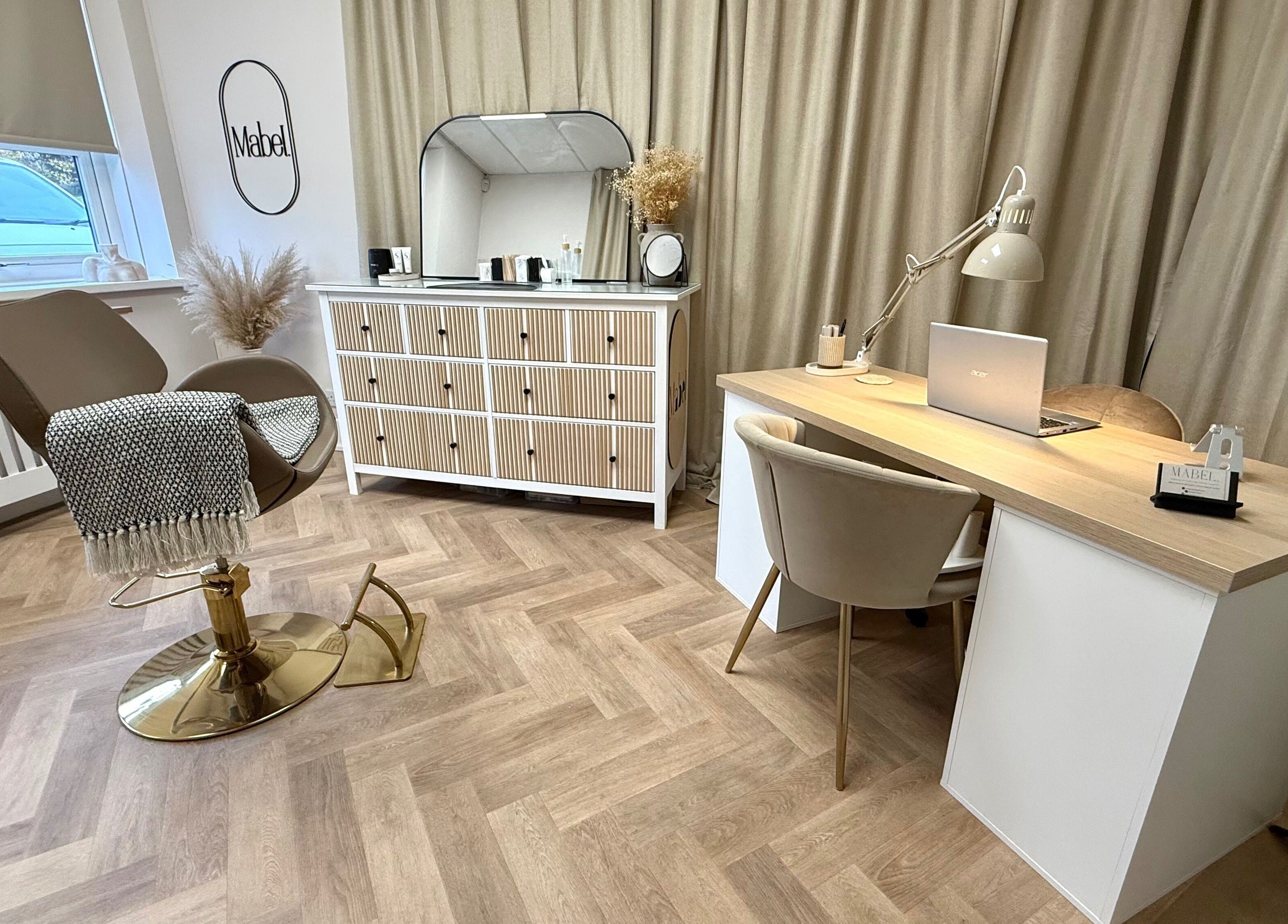 Sophisticated beauty station at Mabel Studio, Blantyre, Scotland, GB with chair, desk, and decor.