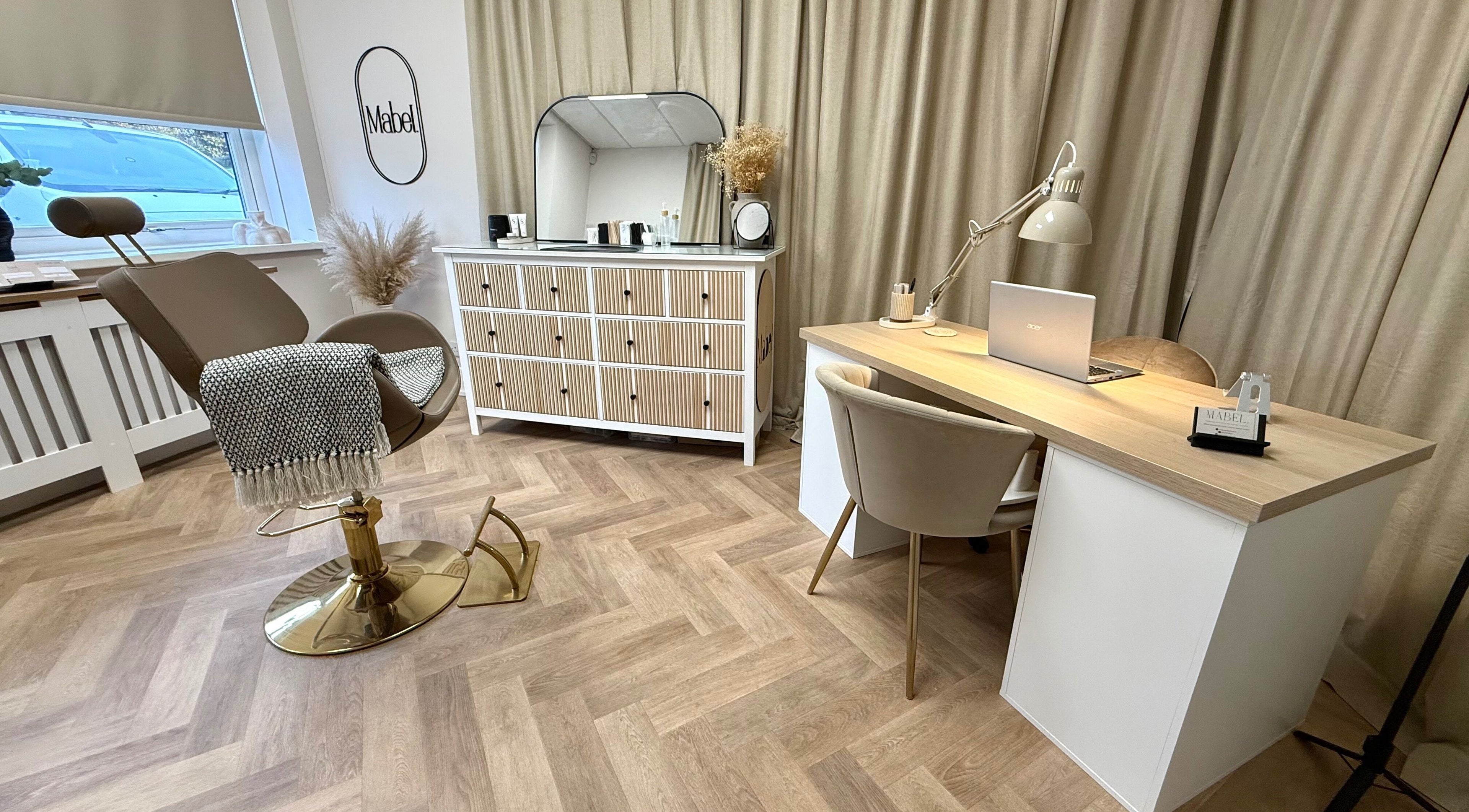 Sophisticated beauty station at Mabel Studio, Blantyre, Scotland, GB with chair, desk, and decor.