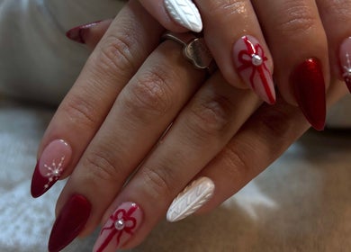 Stylish festive nail art at The Beauty Drop Norwich, Blofield, England, GB with red and white designs.