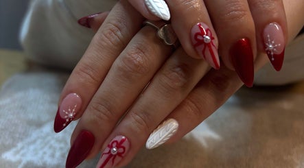 Stylish festive nail art at The Beauty Drop Norwich, Blofield, England, GB with red and white designs.
