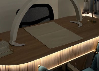 Elegant nail station at The Beauty Drop Norwich, Blofield, England, GB, featuring ambient lighting and luxury seating.