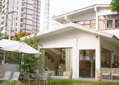 Ozen Home Spa Cafe's serene patio with lush greenery in Pattaya, Chon Buri, TH.