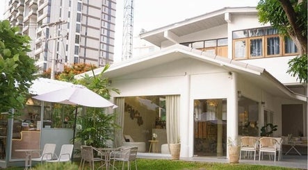 Ozen Home Spa Cafe's serene patio with lush greenery in Pattaya, Chon Buri, TH.