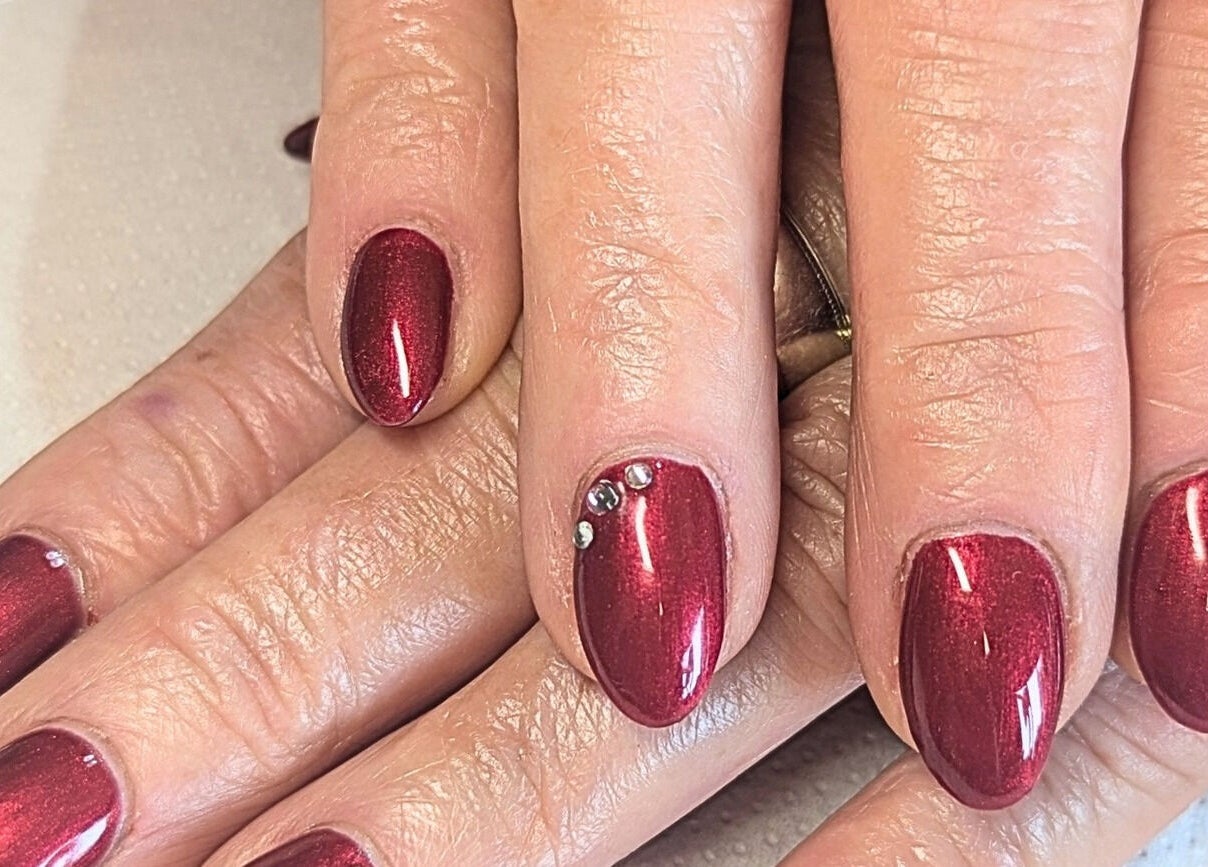 Elegant ruby red nails with rhinestones at Bare Nailscessity @ Hidden Beauty, East Cowes, England, GB.