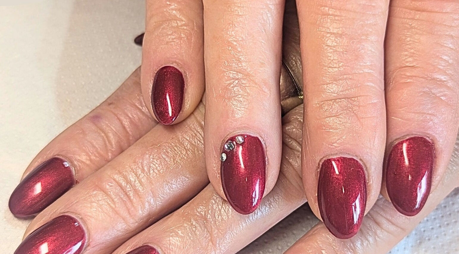 Elegant ruby red nails with rhinestones at Bare Nailscessity @ Hidden Beauty, East Cowes, England, GB.