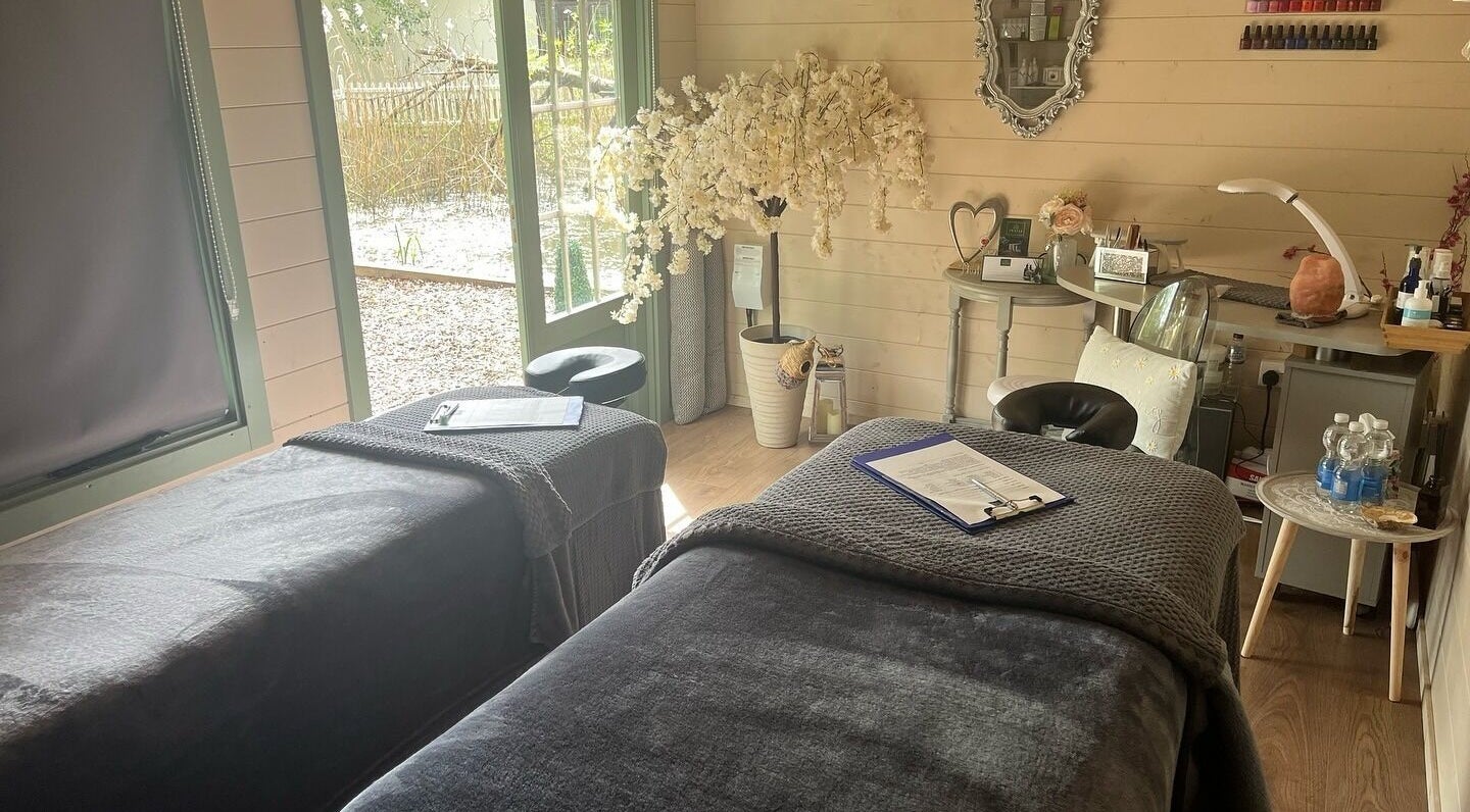 Relaxing massage room at Thalia Massage and Beauty in Colchester, England, GB, with elegant decor and massage tables.