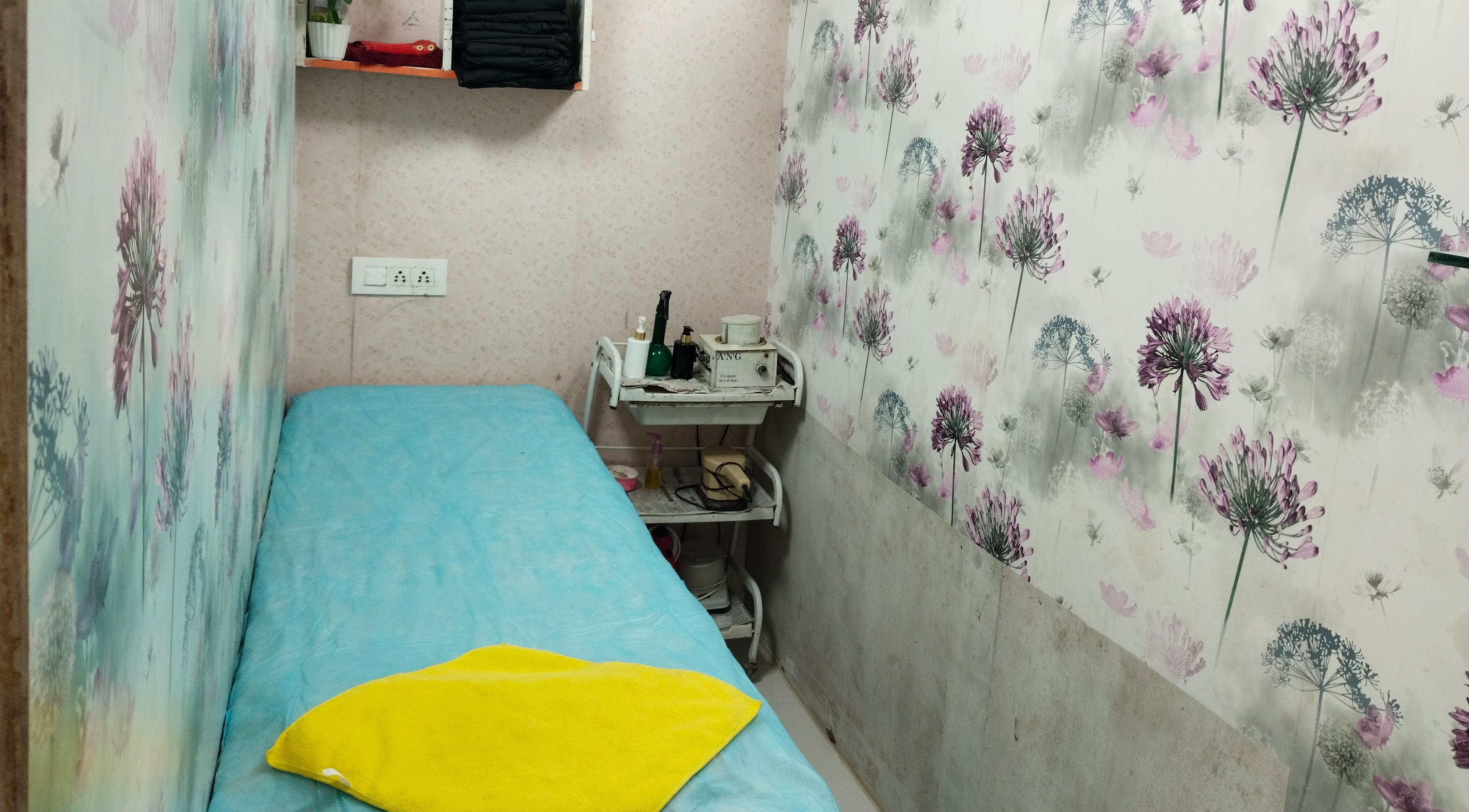 Tranquil treatment room at Geet Salon Professional (for Ladies), Noida, Uttar Pradesh, IN, with floral decor.