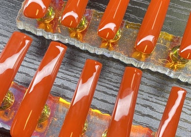 Bright orange nail set display at TBH Tha Black Hippie, Oroville, California, US.
