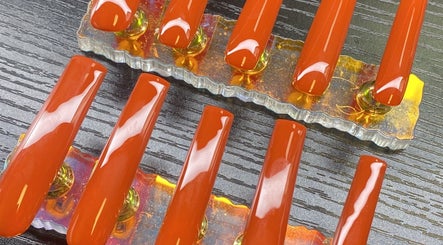 Bright orange nail set display at TBH Tha Black Hippie, Oroville, California, US.