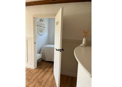 Open door to a tranquil treatment room at Belles Beauty Therapy, Ormskirk, GB, showcasing its calm interior.