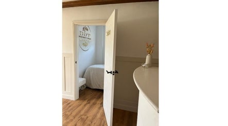 Open door to a tranquil treatment room at Belles Beauty Therapy, Ormskirk, GB, showcasing its calm interior.