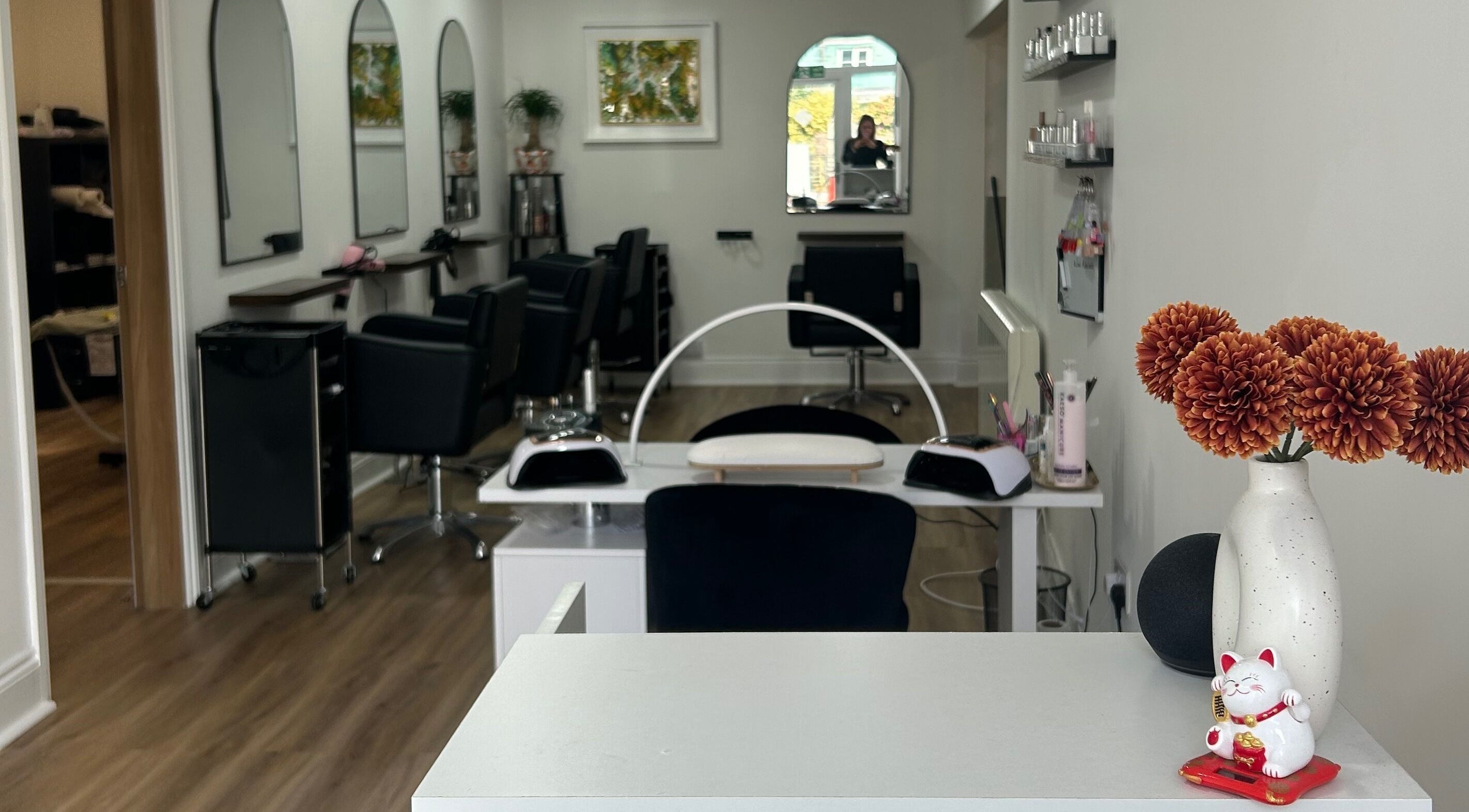 Interior of Moxie Hair and Beauty in Penryn, England. Modern salon with stylish chairs and decor.