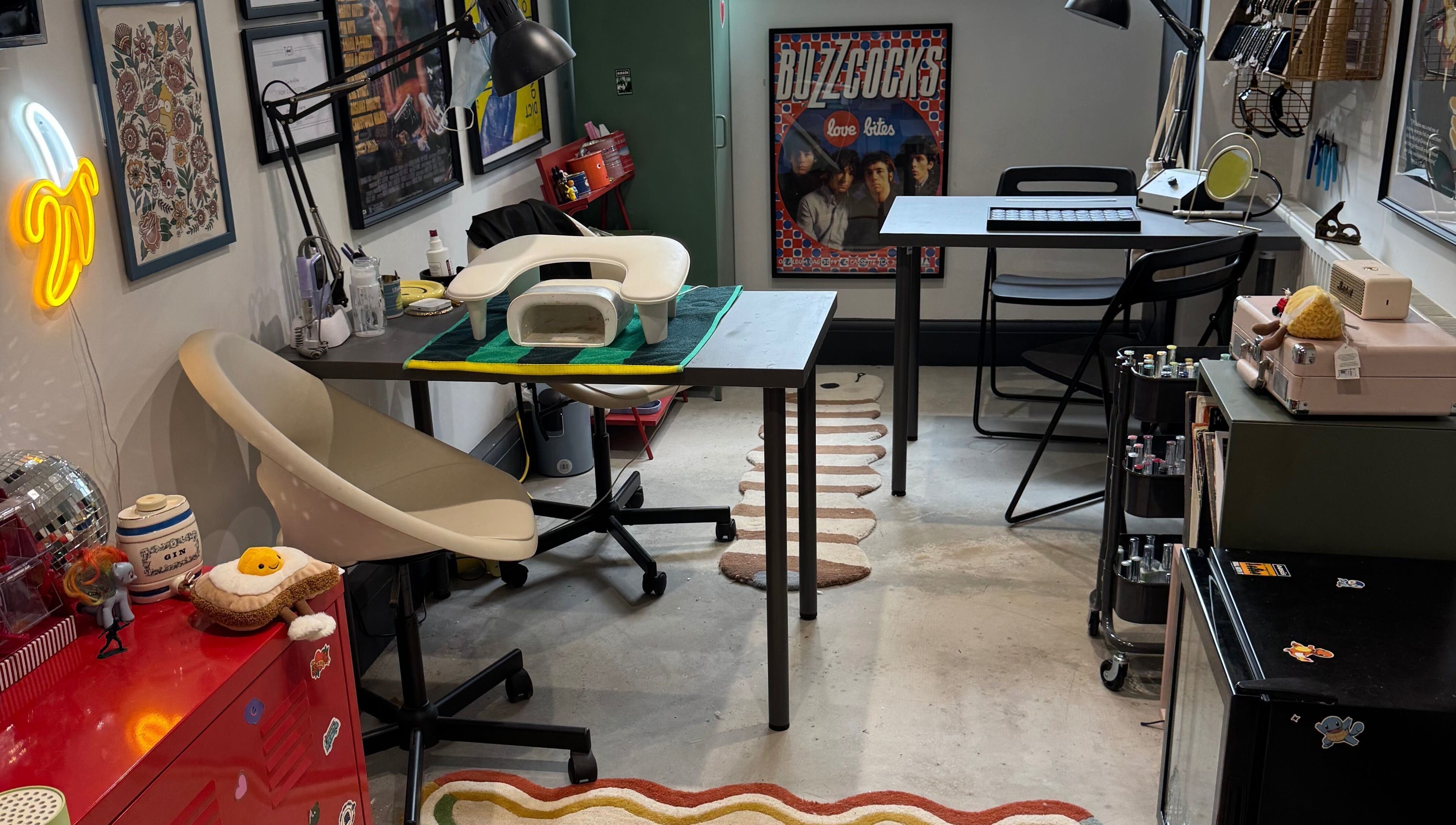 Griff’s Gel Studio in Urmston, England, features a quirky workspace with artistic decor and modern nail equipment.