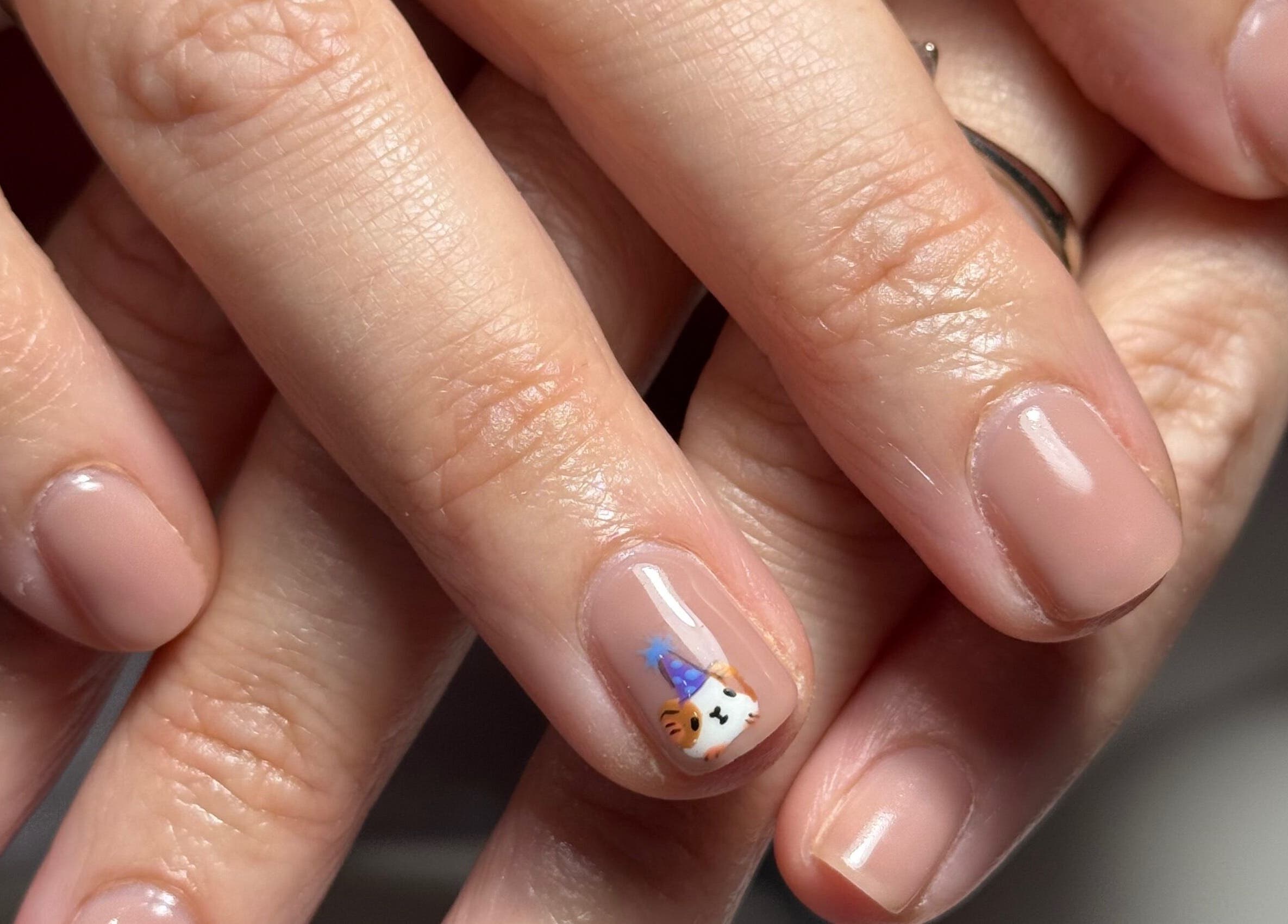 Elegant nail art at Griff’s Gel Studio - Urmston, England, GB. Featuring soft nude polish and cute animal design.