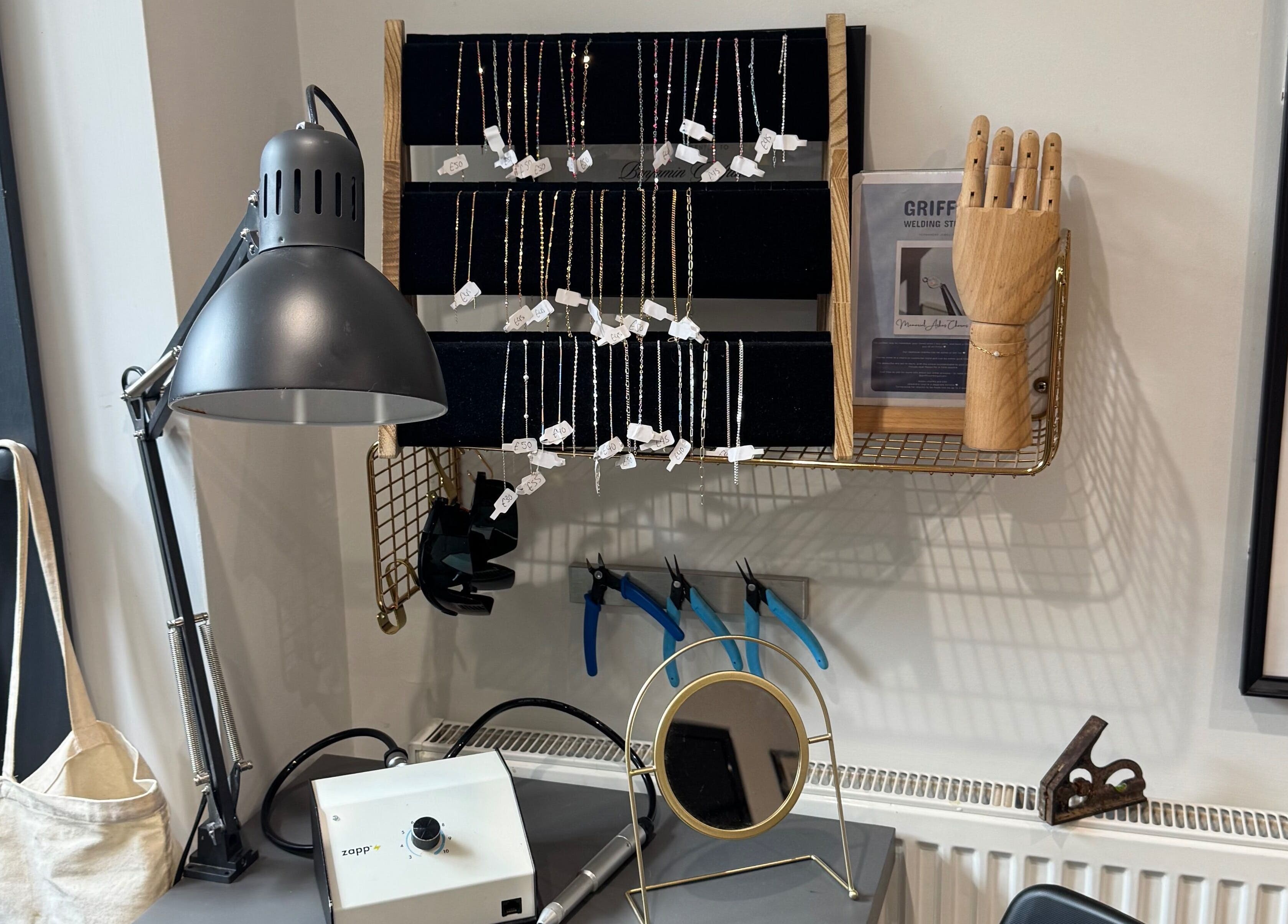 Griff's Weld Studio in Urmston, England with jewelry, tools, and decor, offering a creative ambiance.