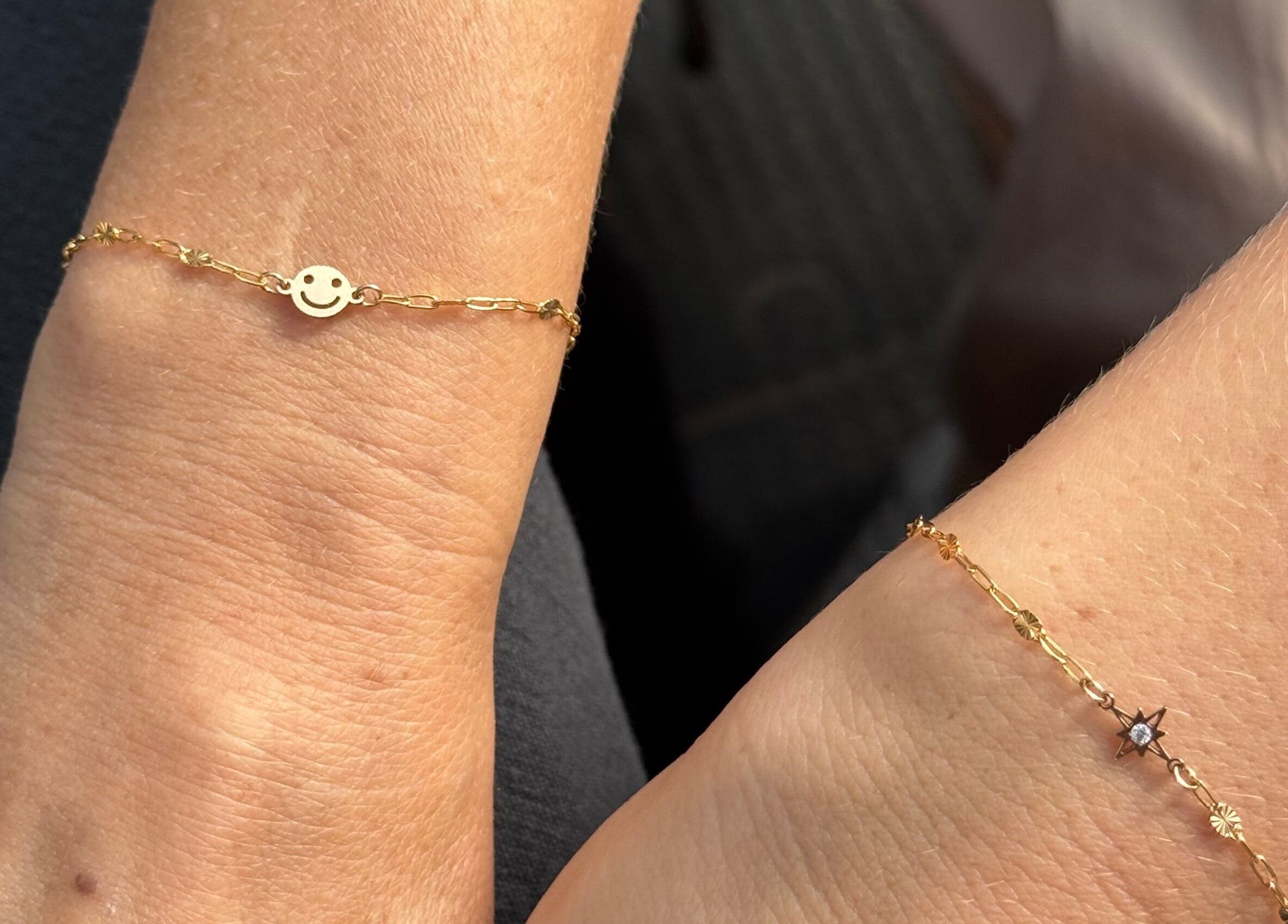 Elegant gold bracelets with charms at Griff’s Gel Studio, Urmston, England, GB.