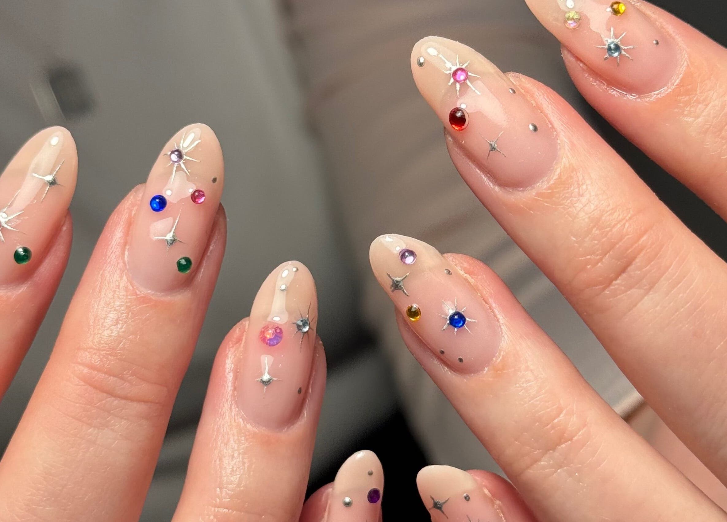 Close-up of artistic nail designs with gemstones at Griff’s Gel Studio, Urmston, England, GB.