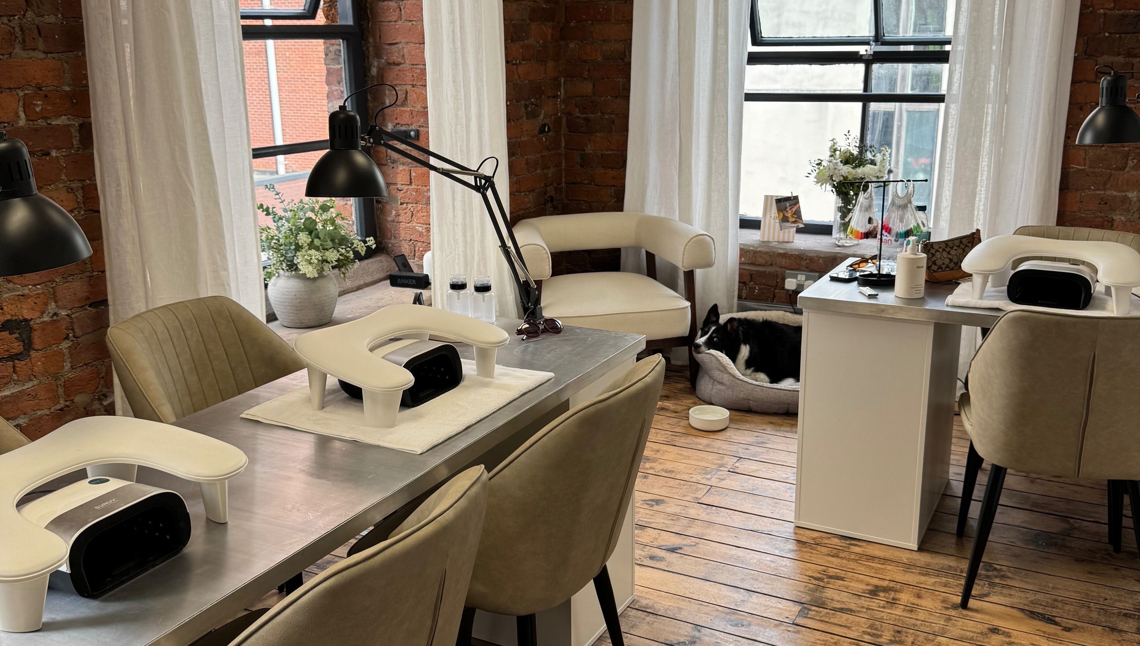 Modern manicure setup at Griff’s Gel Studio, Manchester. Cozy ambiance with natural light and plush seating.