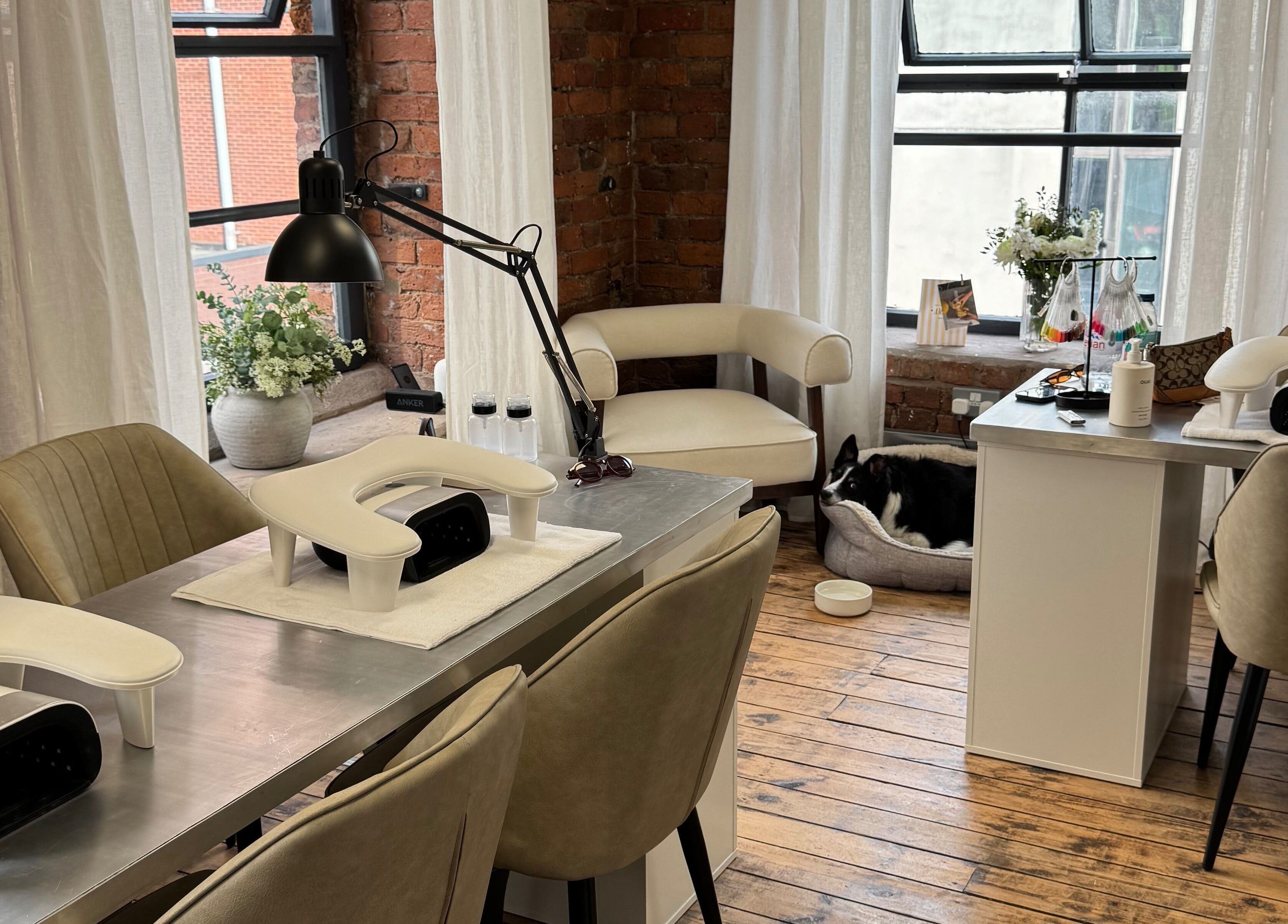 Modern manicure setup at Griff’s Gel Studio, Manchester. Cozy ambiance with natural light and plush seating.