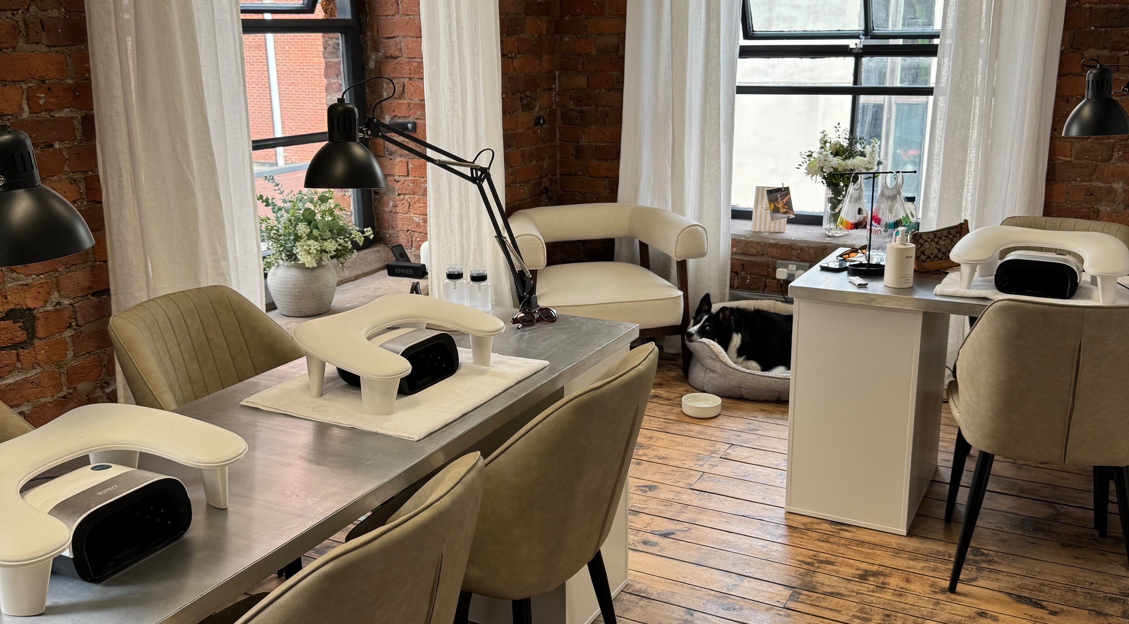 Modern manicure setup at Griff’s Gel Studio, Manchester. Cozy ambiance with natural light and plush seating.