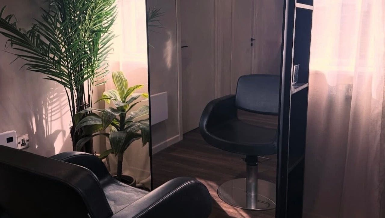 Cozy chair and plants in The Lavender Loft, Cardiff, Wales, GB enhancing a calm atmosphere.