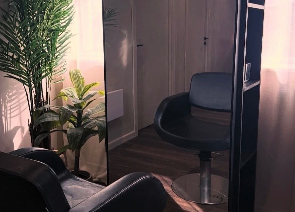 Cozy chair and plants in The Lavender Loft, Cardiff, Wales, GB enhancing a calm atmosphere.