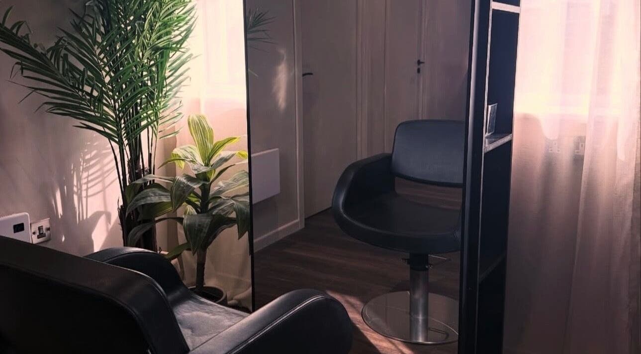 Cozy chair and plants in The Lavender Loft, Cardiff, Wales, GB enhancing a calm atmosphere.