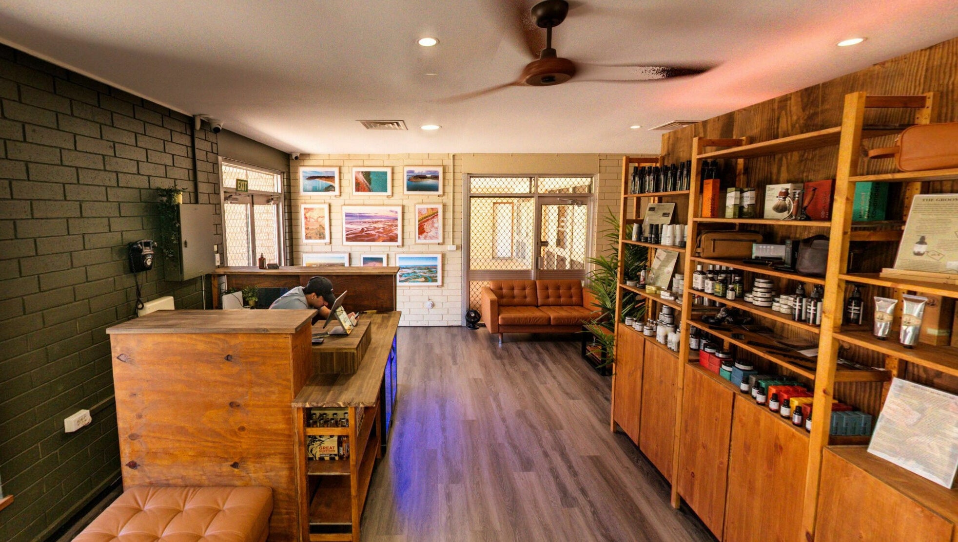 Interior of The Big Beard Cartel Barbershop at Karratha, Western Australia, AU, showcasing wood shelves and seating.
